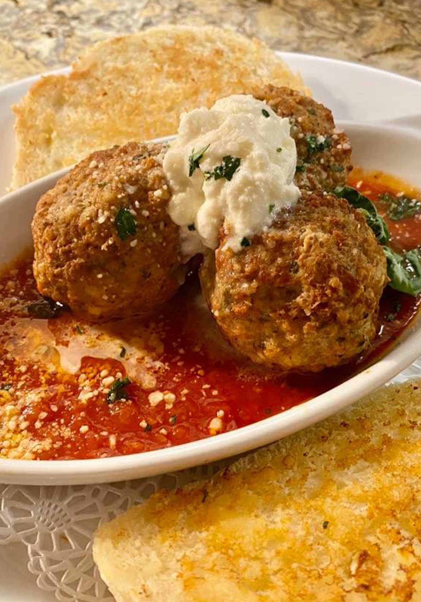 Homemade meatballs marinara topped with herbs at Joe's Place Restaurant